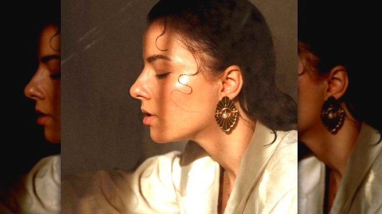 A woman wearing seashell earrings