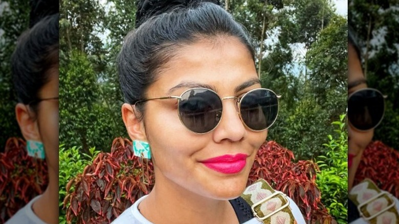 A woman wearing turquoise earrings