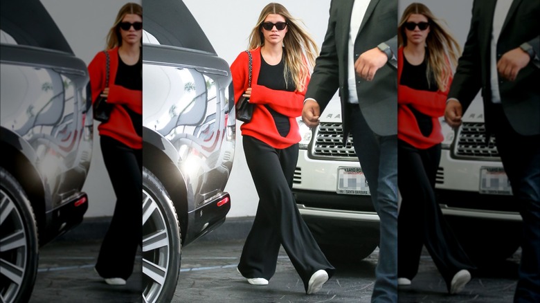 Sofia Richie in red sweater and sunglasses