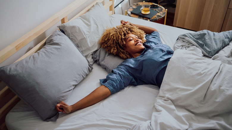 Woman stretching in bed