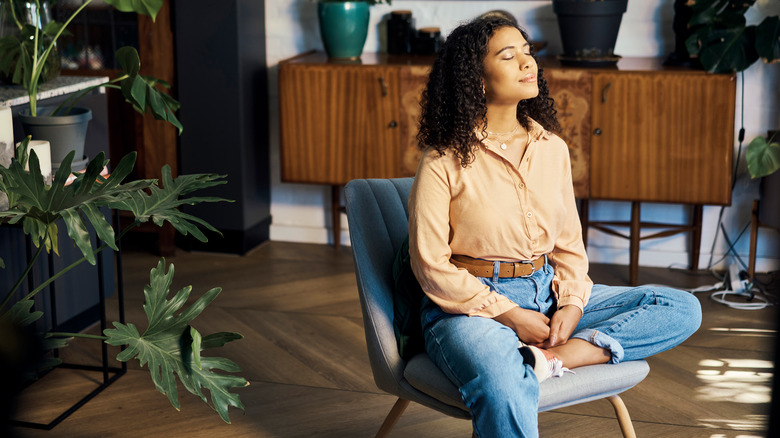 Woman meditating in a chair