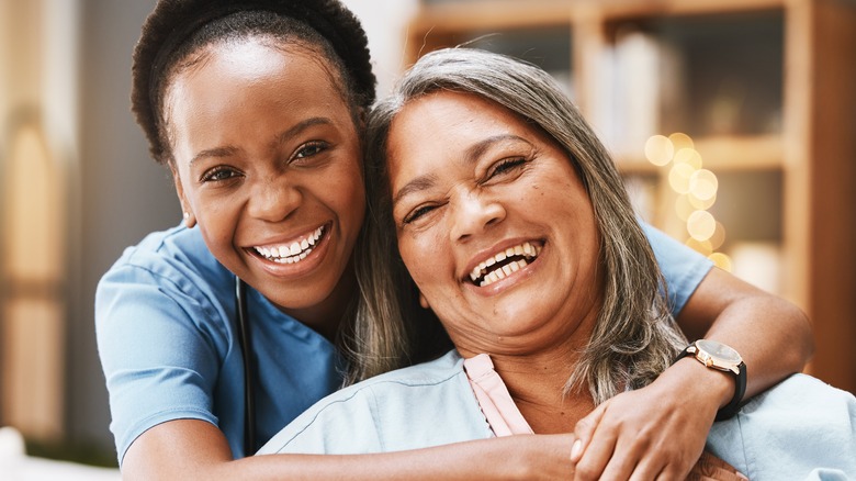 Two women smiling and hugging