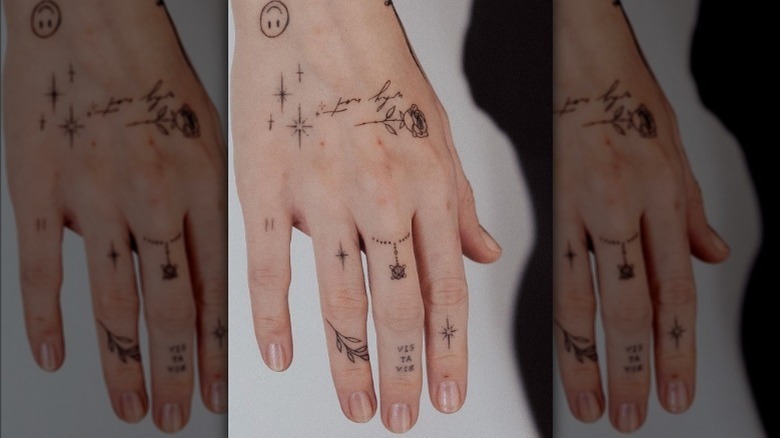 hand tattoo with phrases