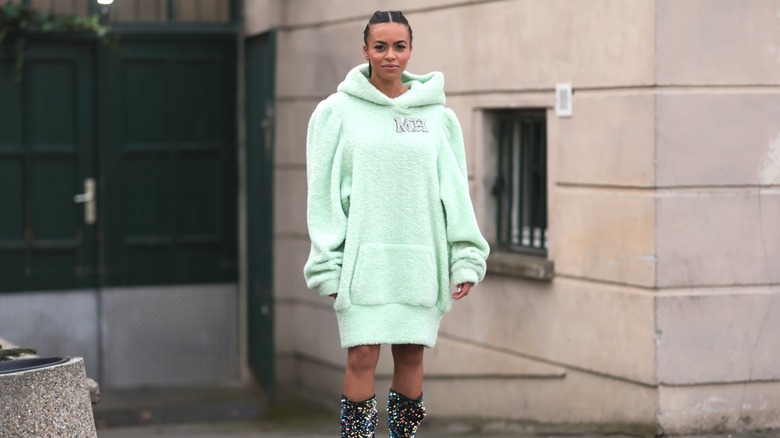 Aminata Belli wearing mint hoodie dress