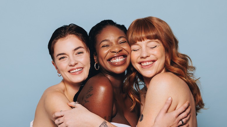 Three women hugging, smiling