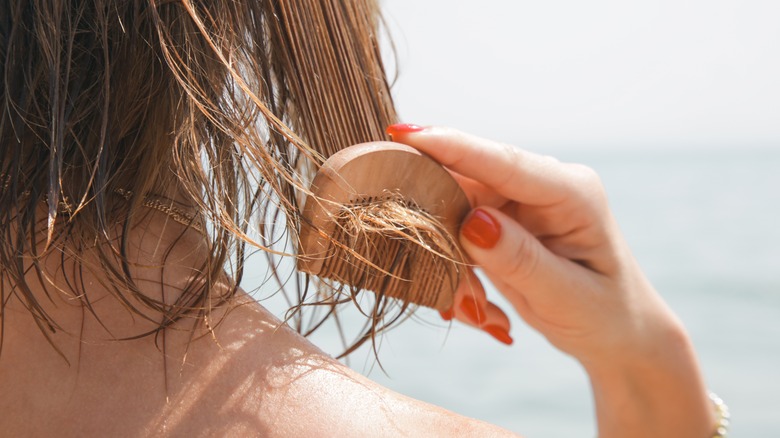 Woman combing her wet hair