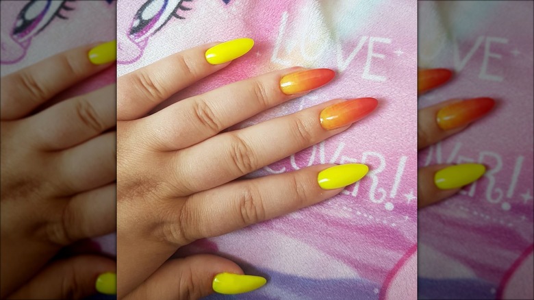 hand with ombre strawberry lemonade nails