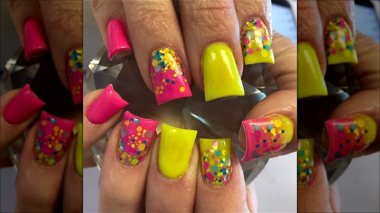 hands with pink yellow confetti nails