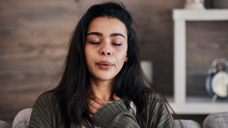 woman thinking with eyes closed