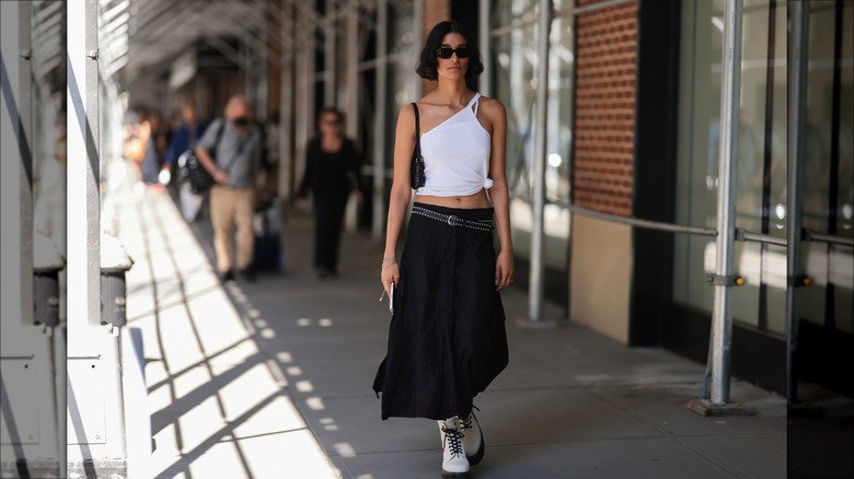 Woman wearing studded belt, maxi skirt