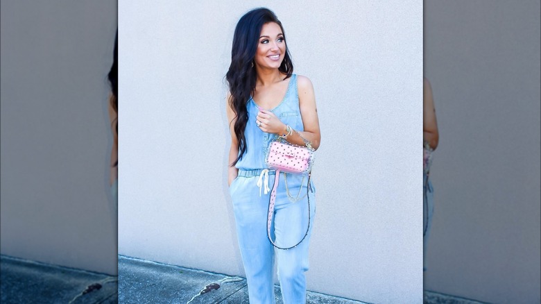 Girl wearing a pink studded bag