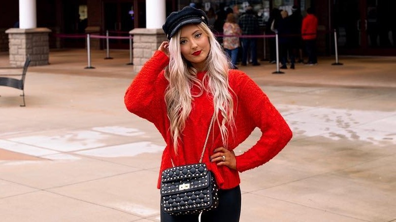 Girl wearing a quilted, studded bag
