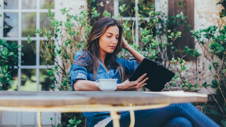 person reading e-book outside