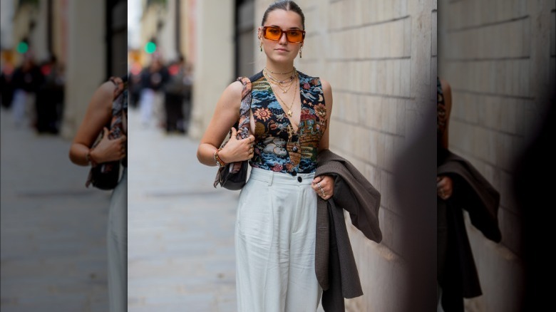 Woman pairing linen pants, printed top