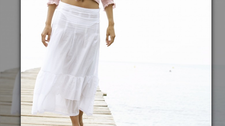 Woman wearing sheer white skirt