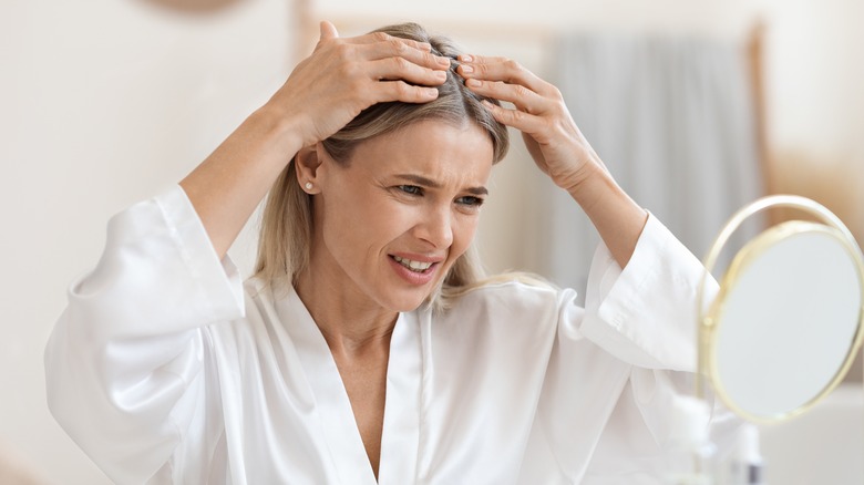 A woman looking at her middle part