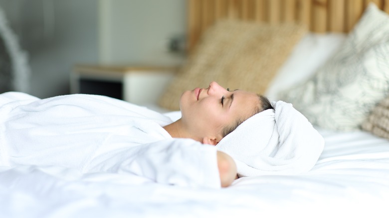 A woman sleeping with wet hair