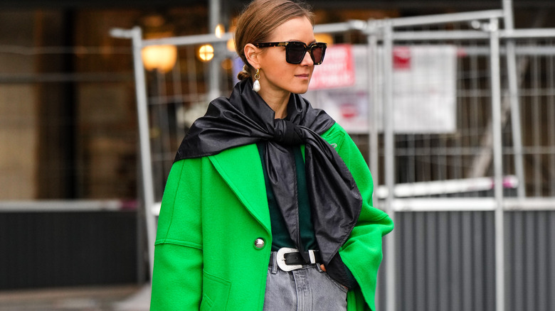 black scarf layered over a green coat
