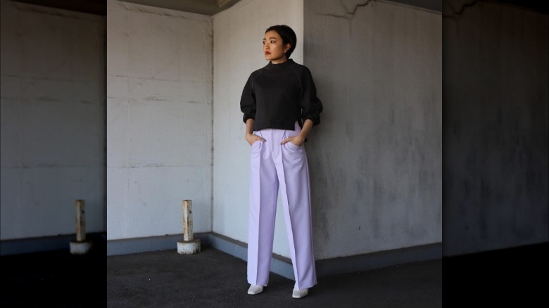 woman wearing lavender trousers and slouchy sweater