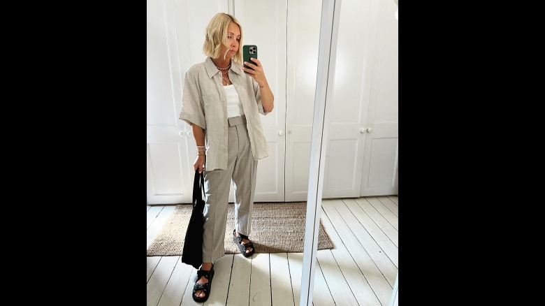 woman wearing trousers, sandals, and linen shirt