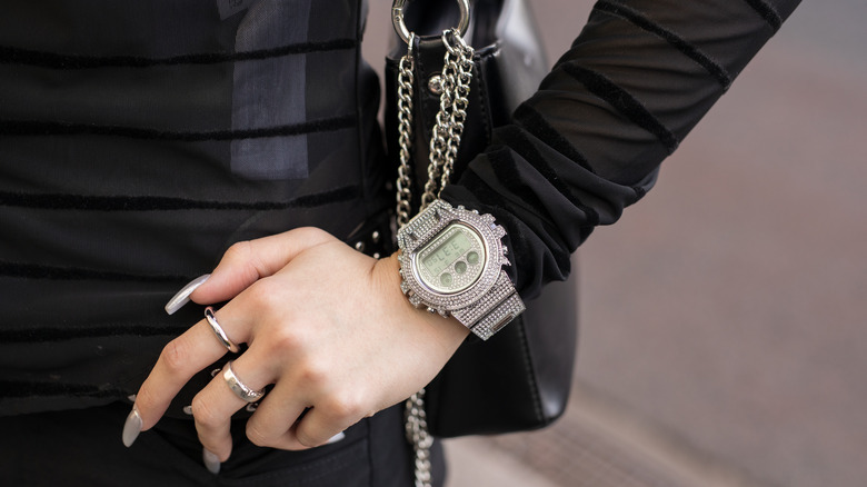 woman wearing silver rings and watch