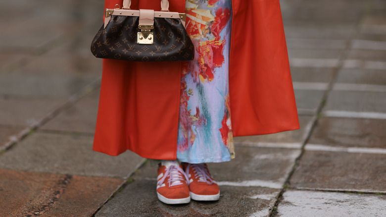 Woman wearing red Adidas Sambas