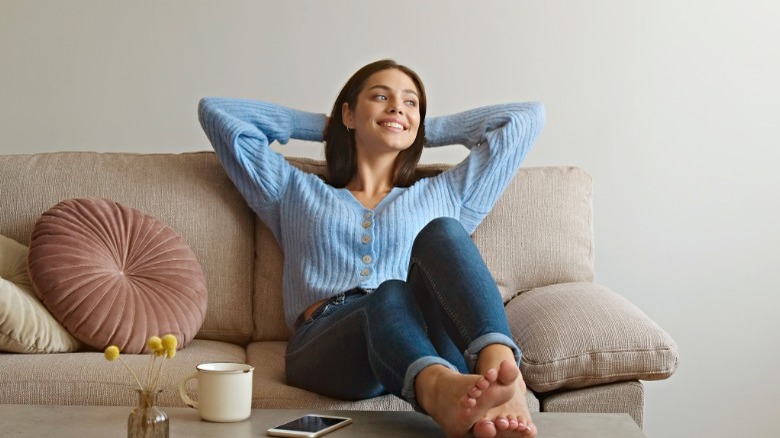 Woman smiling sitting on couch