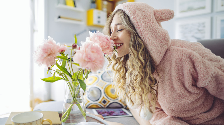 Woman smells flowers