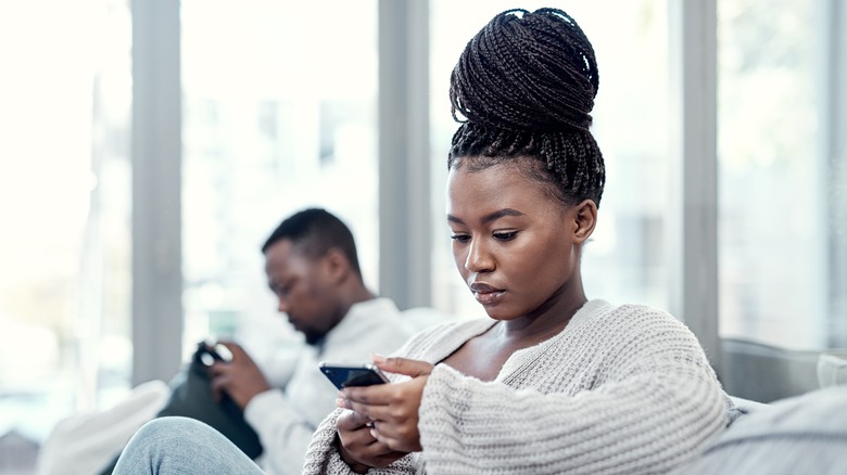 Woman on her phone ignoring her boyfriend 