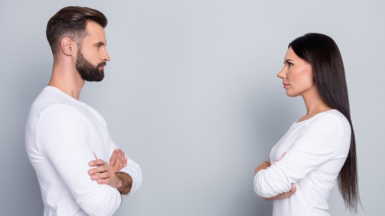 Couples with crossed arms facing each other 