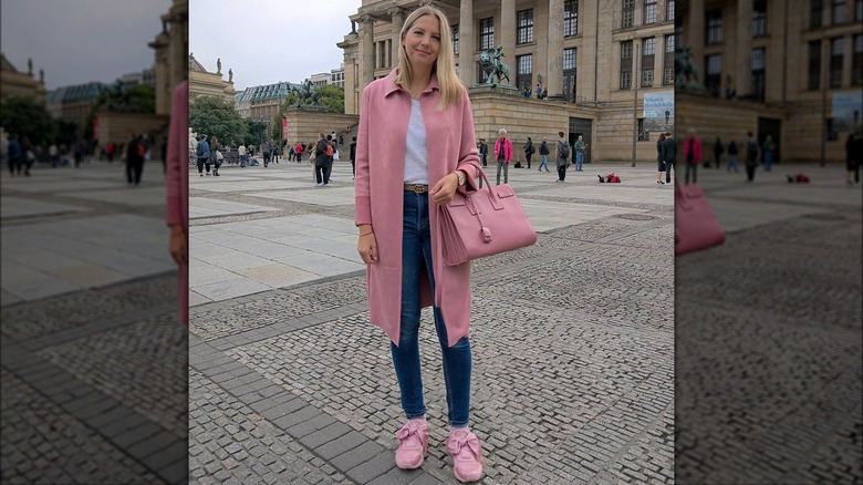 Girl wearing a pink suede coat.