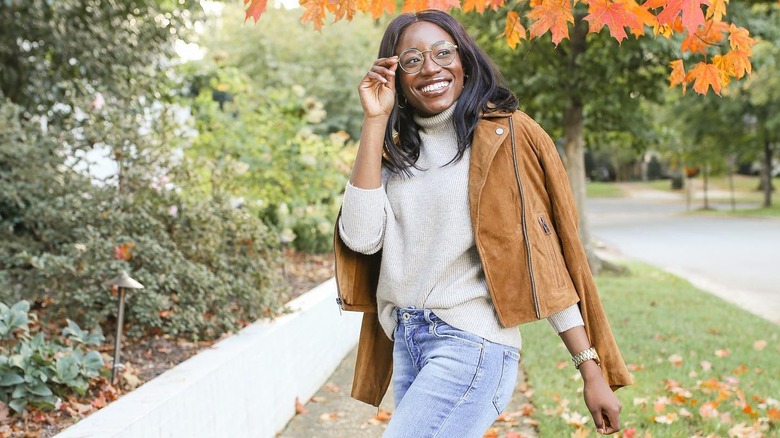 Girl wearing a suede moto jacket.