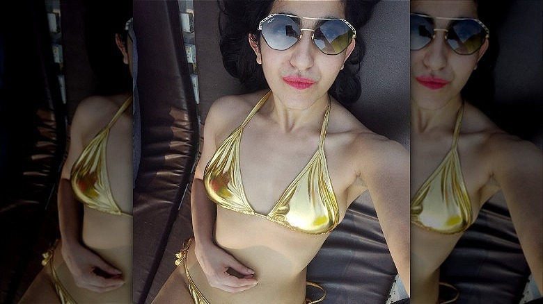 woman wearing gold metallic bathing suit
