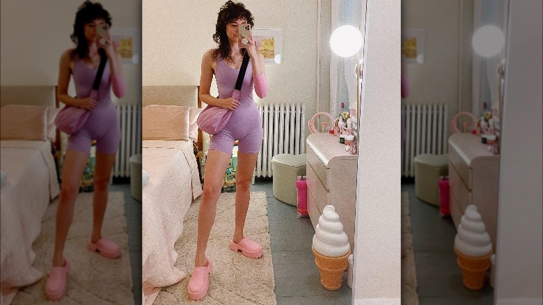 Woman wearing pastel pink clogs