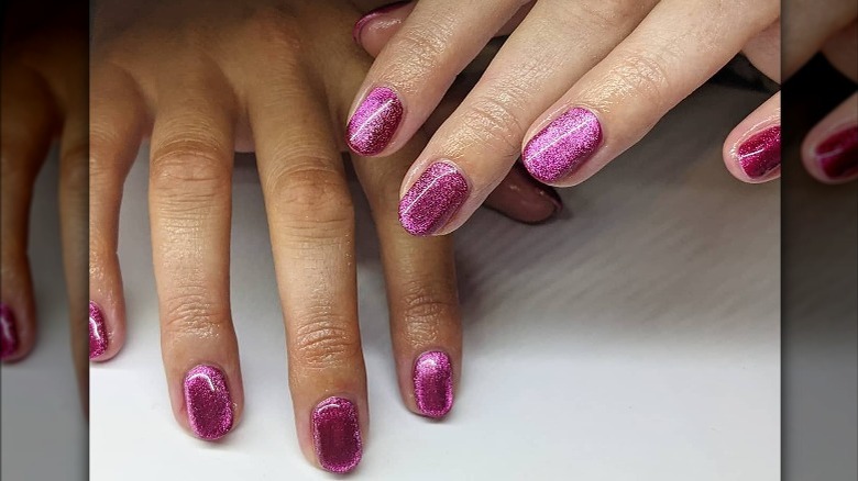 Hand with purple velvet manicure