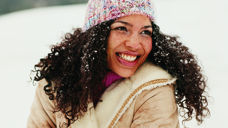 Smiling woman outside in snow