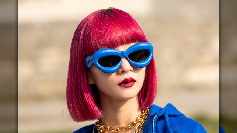 Woman in thick blue sunglasses