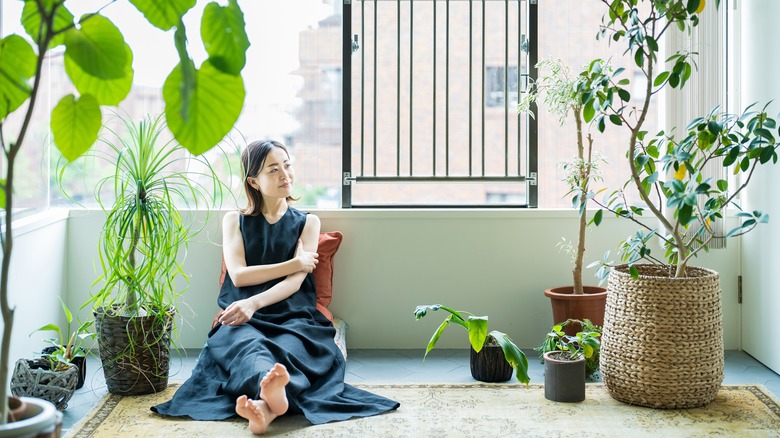 Woman in her home with houseplants