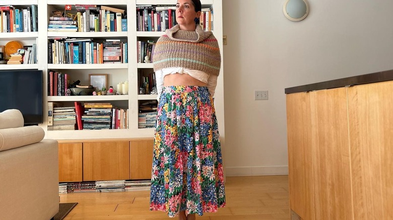 Person wearing colorful shrug, skirt