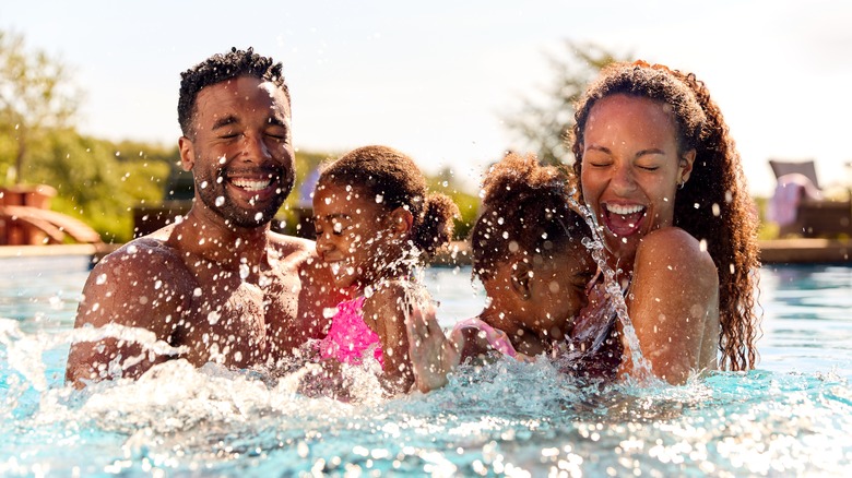 Woman in the pool with her family