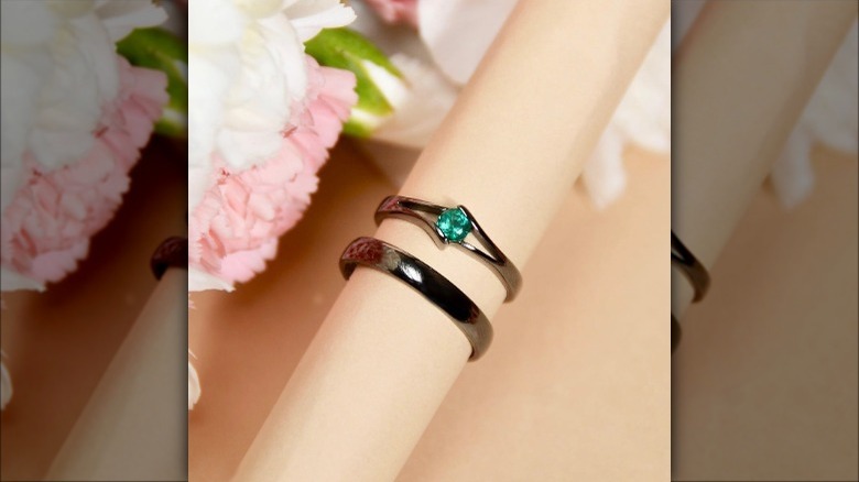 two black gold rings on a bar
