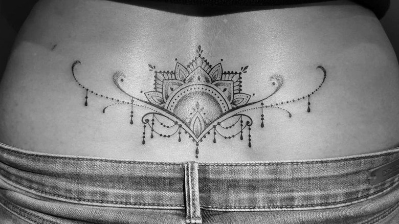 intricate ornamental lower back tattoo