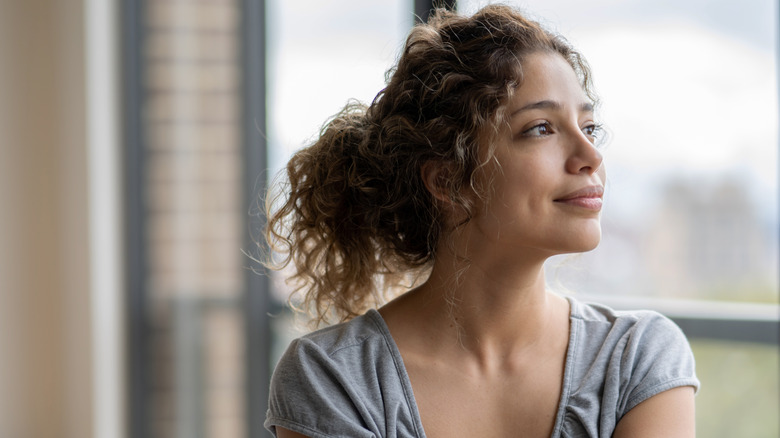 woman looking out window