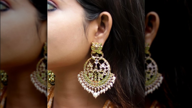 Woman wearing large chandelier earrings