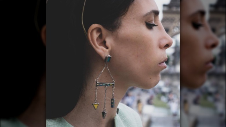 Woman wearing abstract chandelier earrings