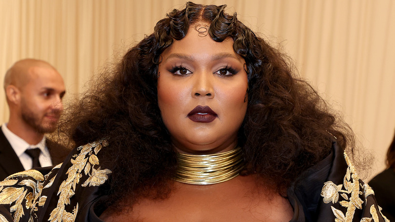 Lizzo in black and gold gown