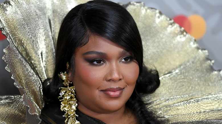 Lizzo in gold cape outfit