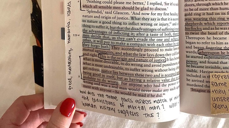 Woman's hand opening annotated novel