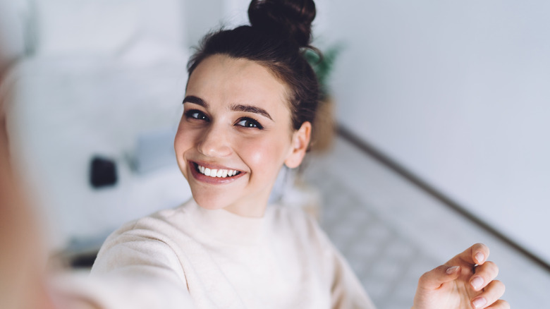 smiling woman taking a selfie