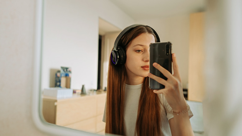 A woman taking a mirror selfie